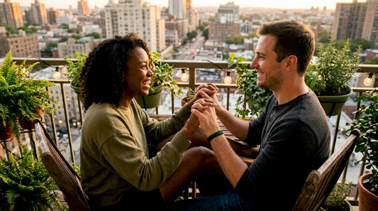 Couple holding hands and smiling warmly on couch