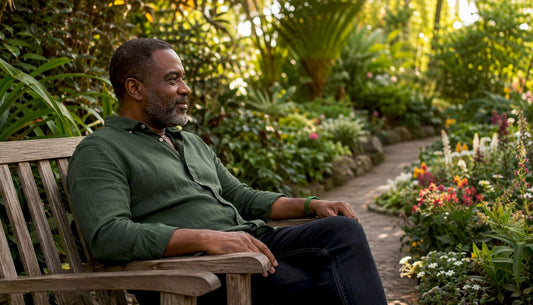 Middle-aged man sitting thoughtfully outdoors